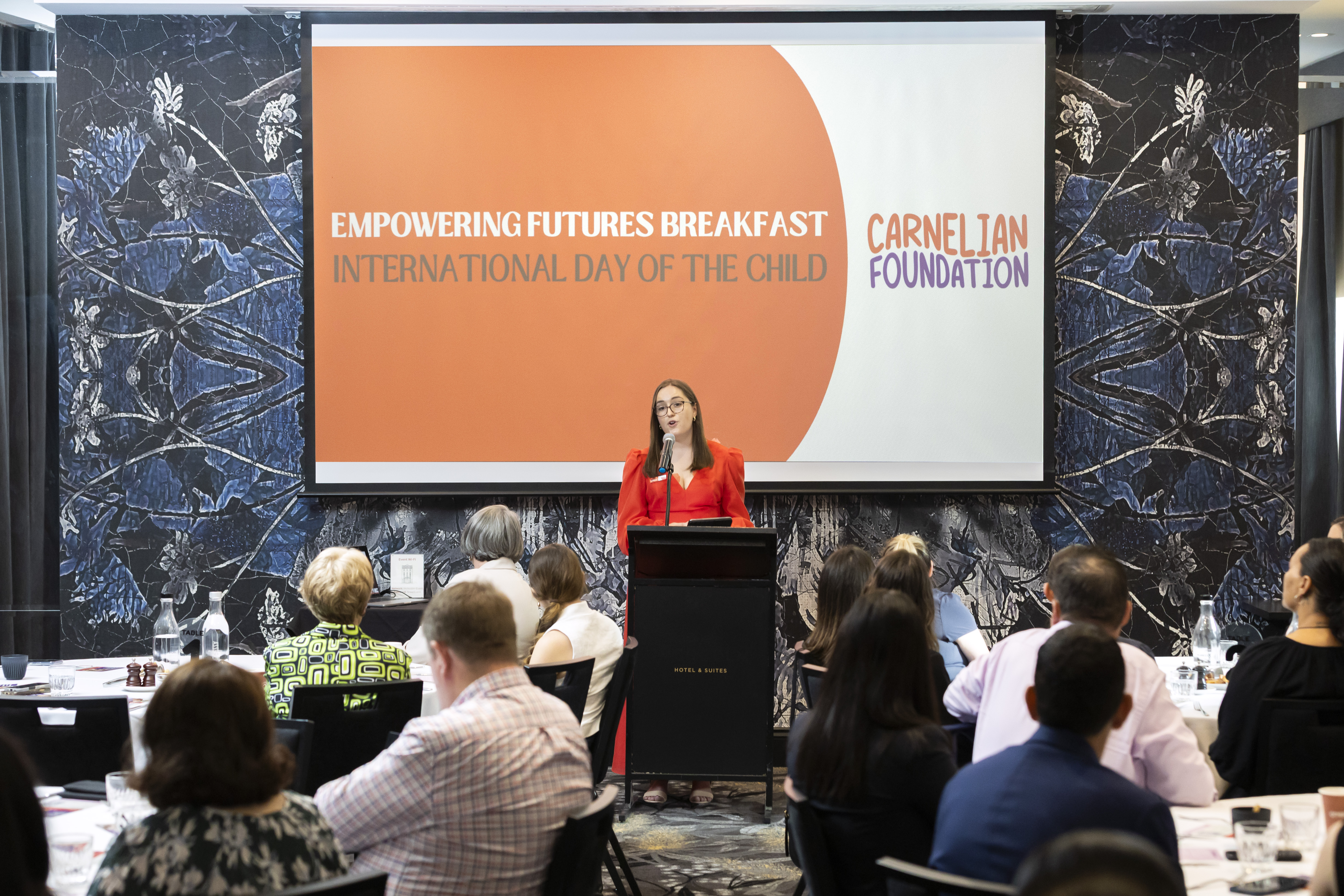 Emi Hall speaking at the Carnelian Foundation Empowering Futures Breakfast